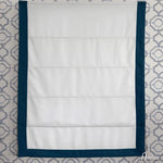 Front view of a flat Roman shade in white with teal border, fully extended, highlighting its clean and modern design for window treatments.