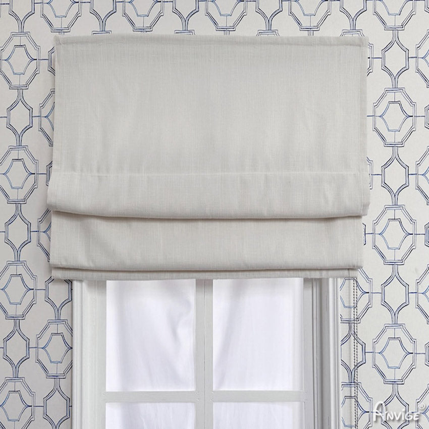 Anvige Flat Roman Shades in light fabric, mounted on a window with geometric wallpaper. Customizable for light filtering or blackout.