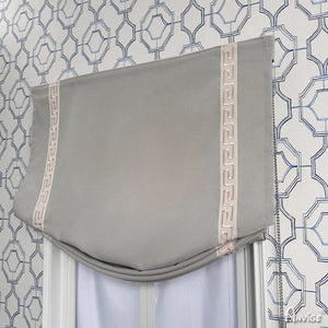 Gray Roman shade with pink trim in a relaxed style, mounted on a window with geometric wallpaper. Perfect for light filtering.