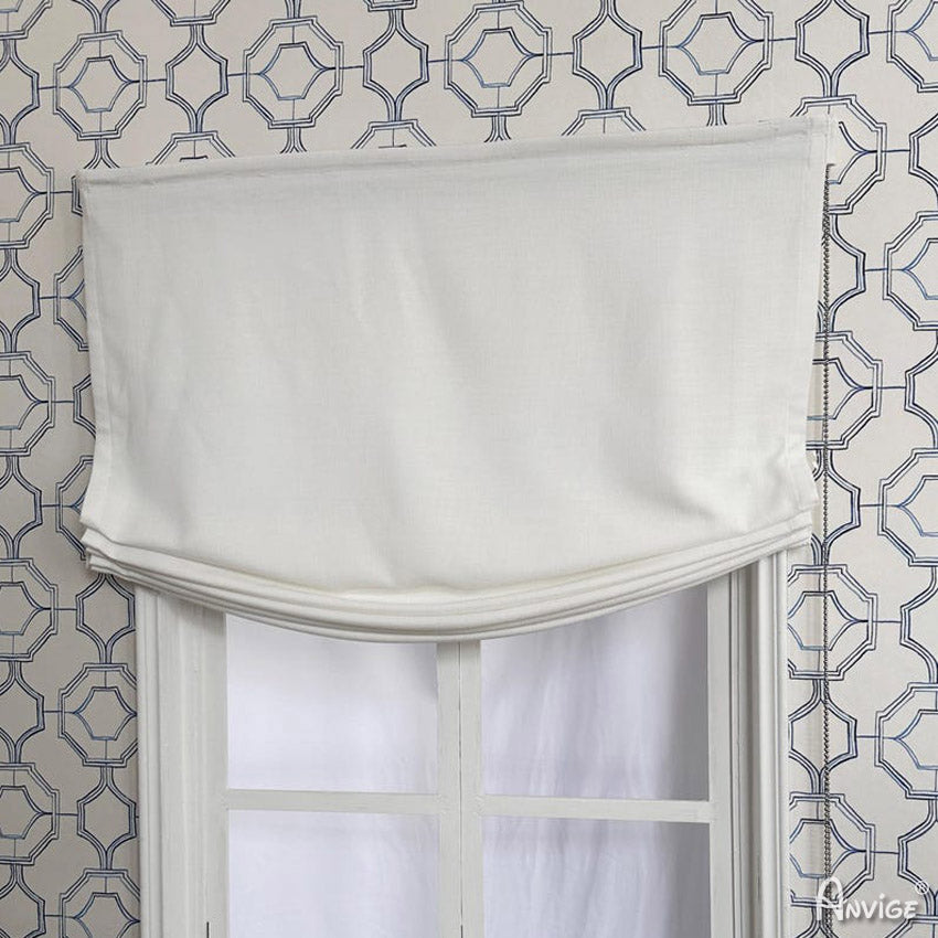 Custom Relax Roman Shades in white fabric, partially drawn, offering a stylish and functional light-filtering window treatment.