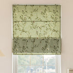 Anvige flat Roman shade with green floral print, installed on a window, showcasing its elegant design and light-filtering fabric.