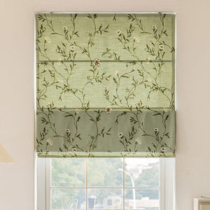 Anvige flat Roman shade with green floral print, installed on a window, showcasing its elegant design and light-filtering fabric.